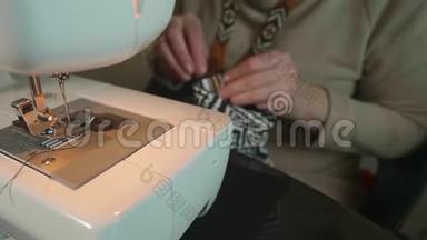 针和纤维缝制的白色手的聚焦视图和前面白色缝纫机的非聚焦视图。